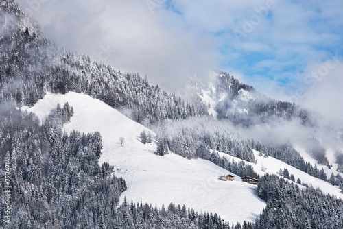 Naklejka ścienna Two winter chalets by the mountain