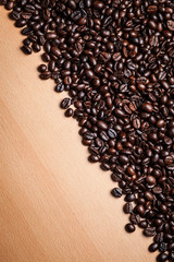 Wall Mural - Coffee beans on wood background