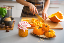Closeup On Young Housewife Cutting Pumpkin For Pickling