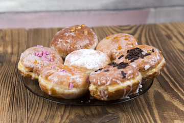 Jummy donuts on wooden table