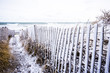 Snow covered beach fence