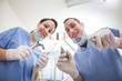 © william87 - Cheerful Dentists Holding Dental Tools Looking at Camera.