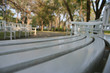 © studio2013 - Long curved row of white park benches
