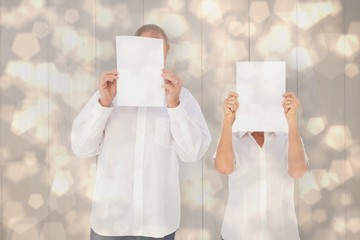Aufkleber - Composite image of couple holding paper over their faces