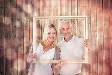 Aufkleber - Composite image of happy couple holding a picture frame