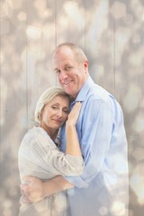 Poster - Composite image of happy mature couple hugging and smiling
