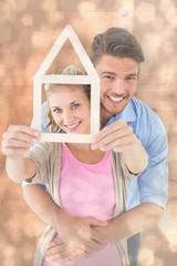 Aufkleber - Young couple hugging and holding house outline