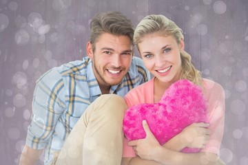 Poster - Attractive young couple sitting holding heart