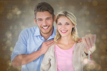 Poster - Composite image of attractive young couple showing new house key
