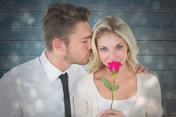 Poster - Handsome man kissing girlfriend on cheek holding a rose