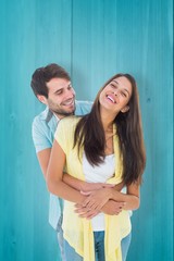 Poster - Composite image of happy casual couple smiling and hugging