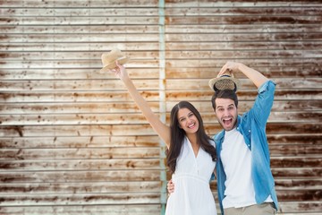 Poster - Happy hipster couple smiling at camera and cheering