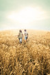 © Cristina Conti - children running into wheat to the sunset