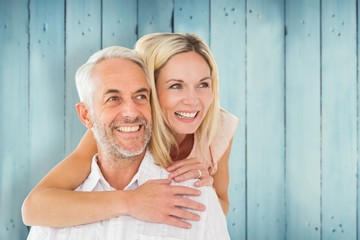 Aufkleber - Composite image of happy man giving his partner a piggy back