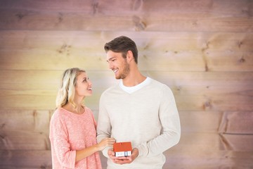 Poster - Attractive couple holding miniature house model