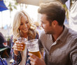© Joshua Resnick - romantic couple drinking beer in plastic cups at outdoor bar