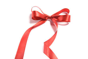 Wall Mural - Shiny red satin ribbon and bow on white background