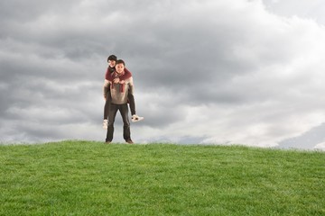 Poster - Composite image of man giving girlfriend piggy back