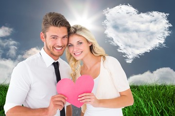 Poster - Composite image of attractive young couple holding pink heart