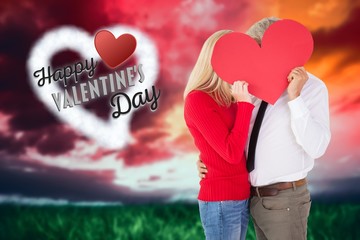 Poster - Composite image of handsome man getting a heart card form wife