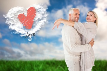 Poster - Composite image of happy couple standing and hugging