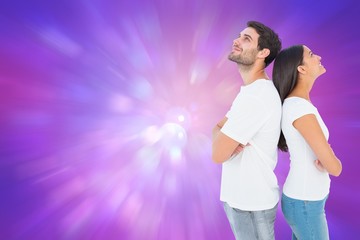 Poster - Composite image of happy couple standing looking up