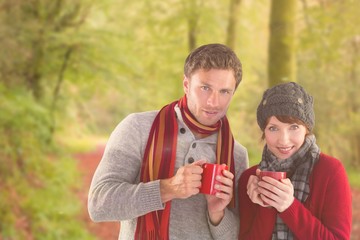 Poster - Composite image of couple both having warm drinks