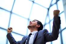 Businessman With Arms Up Celebrating His Victory