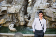 © theartofphoto - Smiling young man in front of fountain in Navona Square, Rome