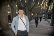 © theartofphoto - Handsome young man in city environment under trees