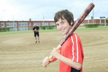 Portrait of a young baseball player in a field