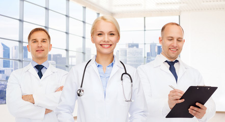 Poster - group of smiling doctors with clipboard