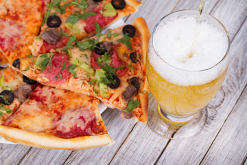 Wall Mural - Glass of beer and pizza