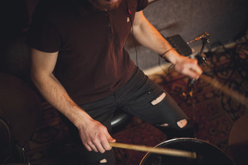 Young drummer playing at drums set