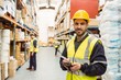 © WavebreakmediaMicro - Smiling worker wearing yellow vest using handheld