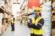 © WavebreakmediaMicro - Smiling worker wearing yellow vest with arms crossed
