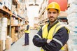 © WavebreakMediaMicro - Smiling worker wearing yellow vest with arms crossed