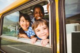 Fototapeta  - Cute pupils smiling at camera in the school bus
