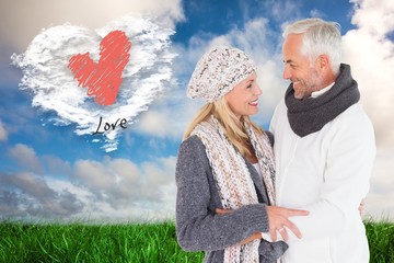 Poster - Composite image of happy couple in winter fashion embracing