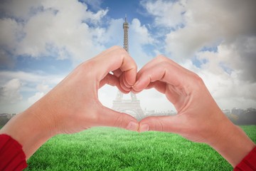Poster - Composite image of woman making heart shape with hands