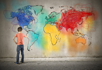 Young boy drawing a world map