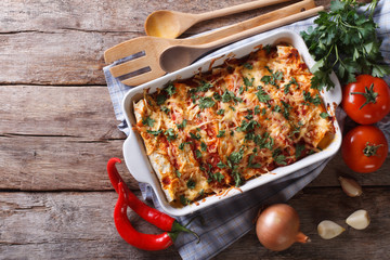 Poster - Mexican enchilada in a baking dish horizontal top view