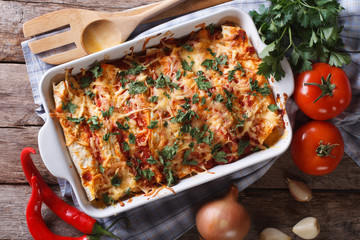 Poster - Mexican enchilada in a baking dish horizontal top view close-up