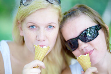 Two sisters in the summer eating ice cream