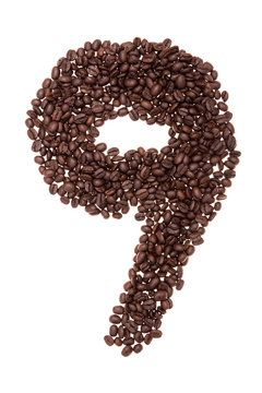 Roasted coffee beans placed in the shape of number nine
