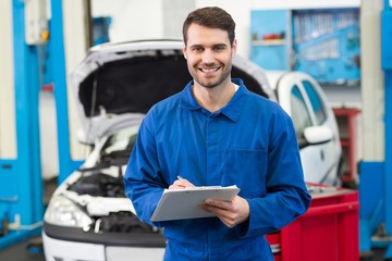 Poster - Smiling mechanic looking at camera