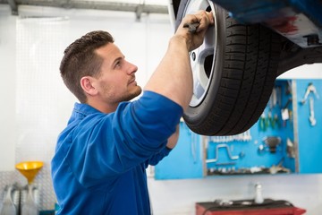 Wall Mural - Mechanic adjusting the tire wheel