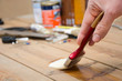 © chandlervid85 - Man varnishing a wood