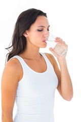 Poster - Pretty brunette drinking glass of water