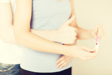 Sticker - woman and man hands with pregnancy test